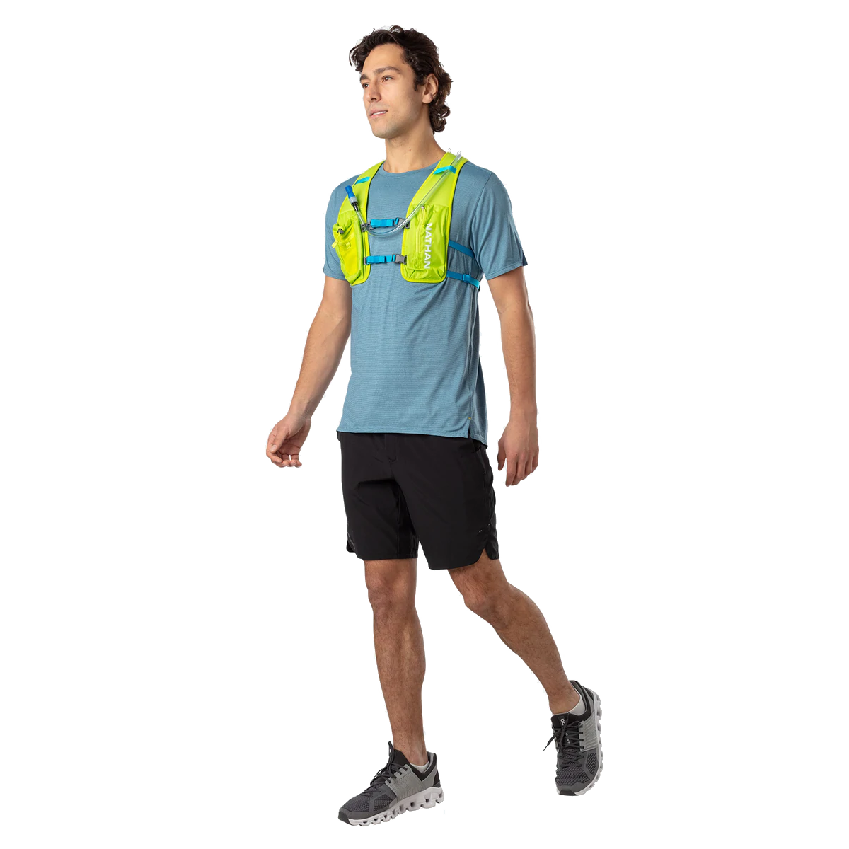 Man wearing Nathan QuickStart 2.0 hydration vest in lime green over blue running shirt