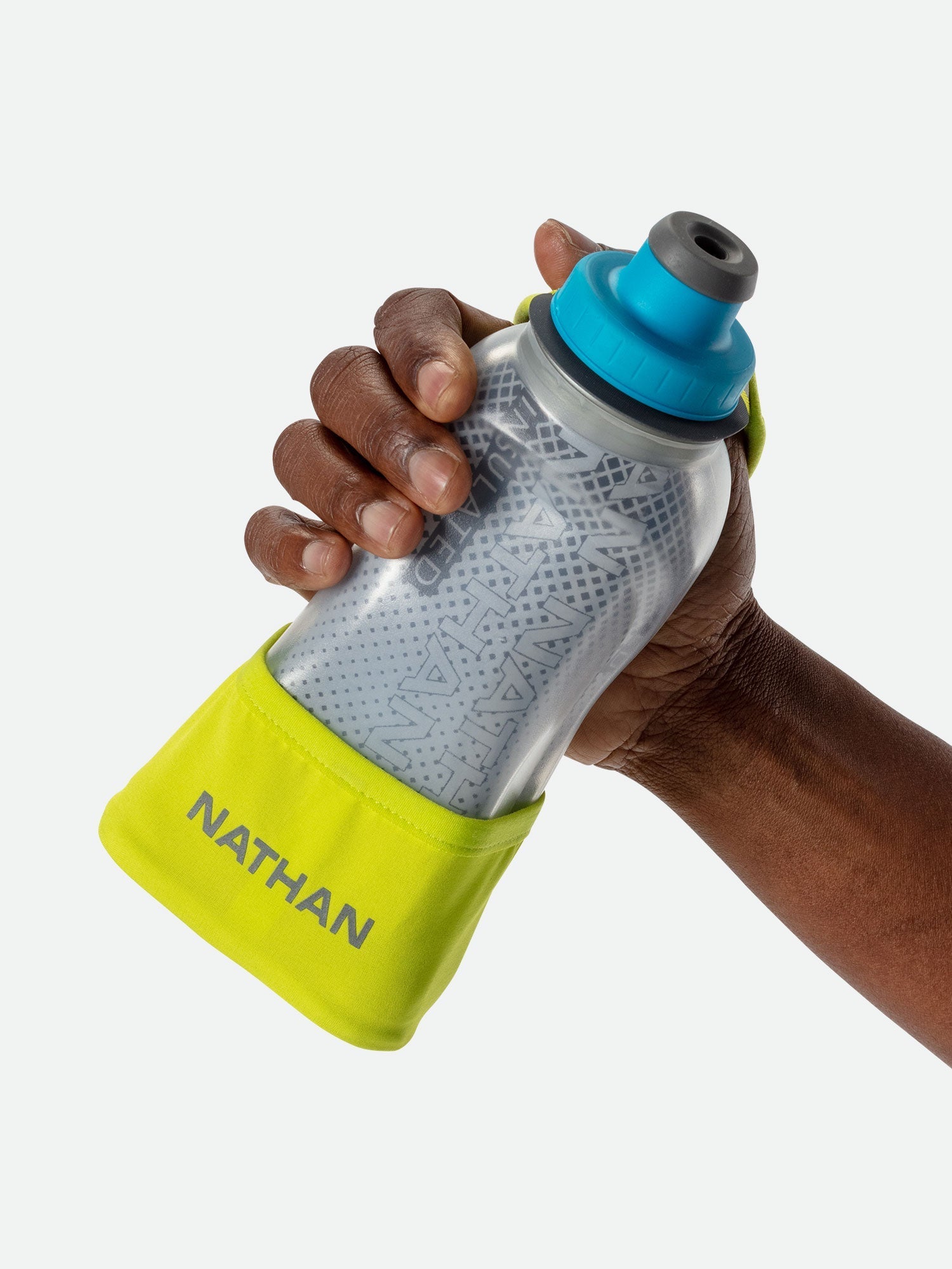 Hand holding Nathan handheld water bottle with blue cap and yellow strap