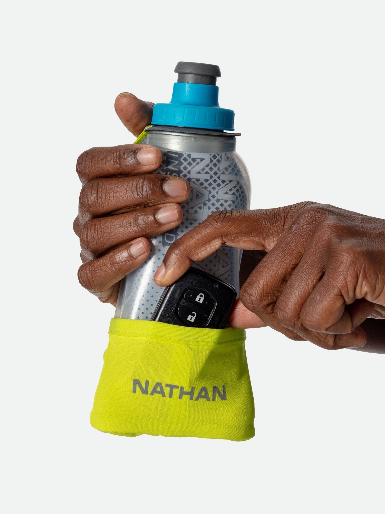 Hands holding Nathan handheld water bottle with blue cap and yellow storage pouch
