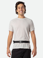 Man wearing Nathan Peak Hydration Waist Pack in black with gold accents around waist