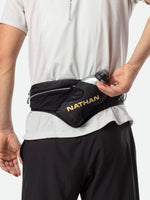 Nathan Peak Hydration Waist Pack in black with gold branding worn around waist