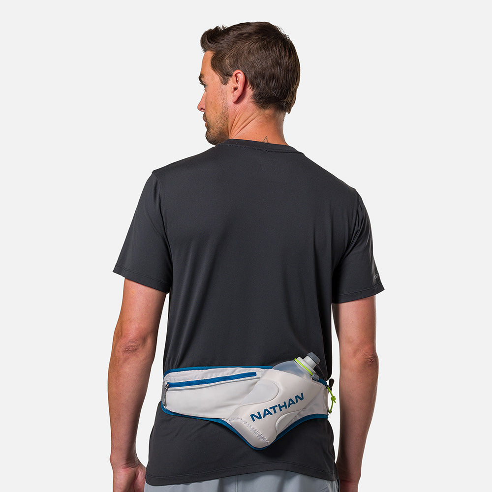 Nathan Peak Hydration Waist Pack in Vapor Grey/Sailor Blue worn by male runner from behind