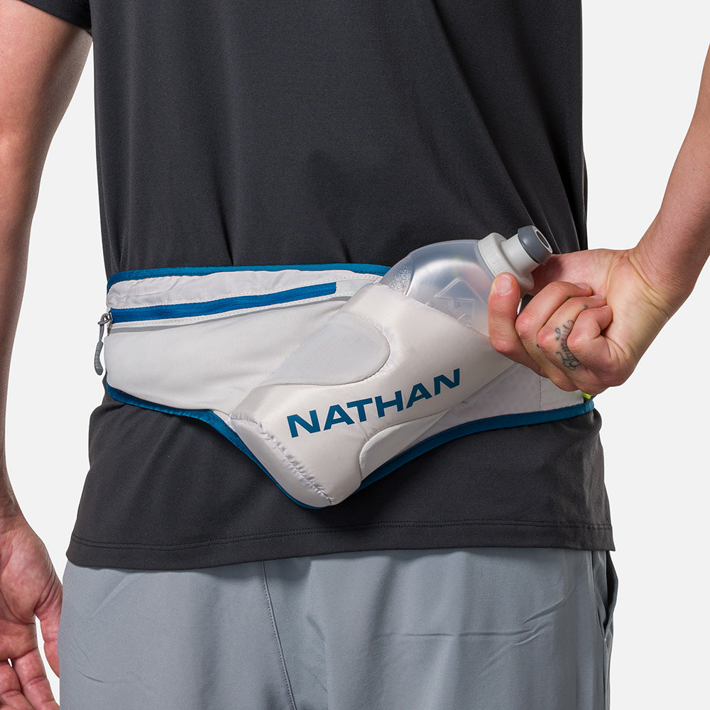 Nathan Peak Hydration Waist Pack in Vapor Grey with Sailor Blue trim worn around waist