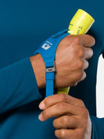 Nathan Polaris 200 R runner's hand torch with blue strap and yellow light head being held