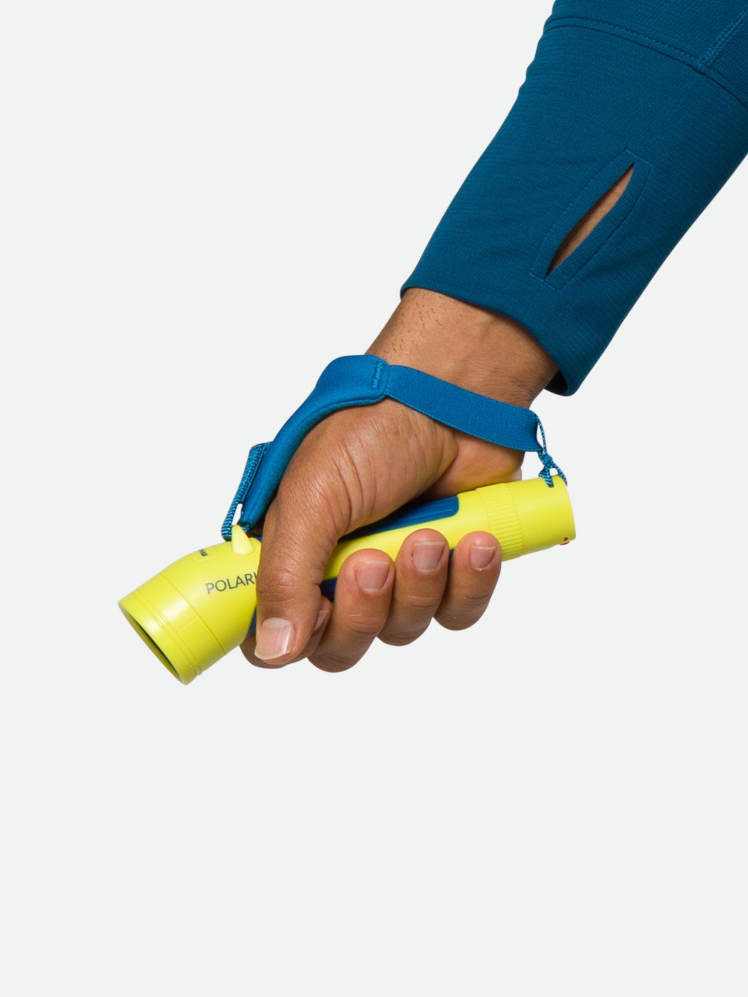 Hand holding yellow Nathan Polaris runner's torch with blue wrist strap against white background