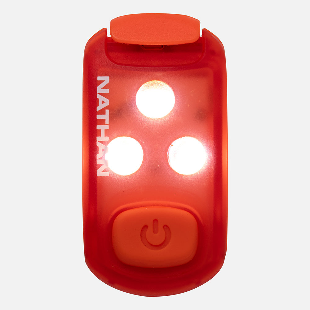 Nathan red strobe safety light with three bright LED lights illuminated and power button