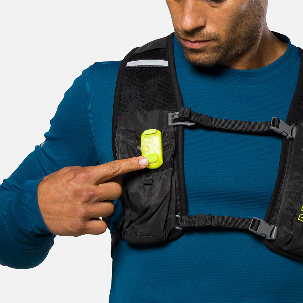 Nathan safety yellow LED strobe light clipped to black running vest chest strap