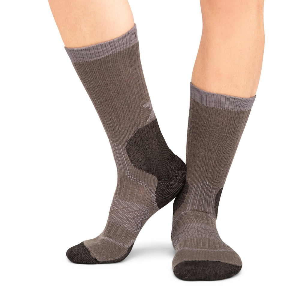 Thorlos Outdoor Crew socks in Silver Fox colorway worn on model's feet against white background