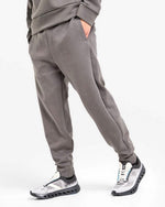 Men's gray taupe sweat pants with elastic waistband and cuffs, professional studio shot