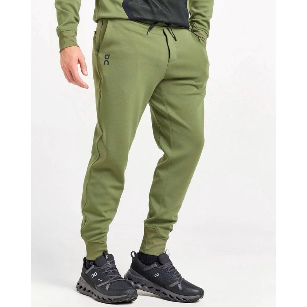 On brand men's sweat pants in taiga green with matching pullover, professional studio shot