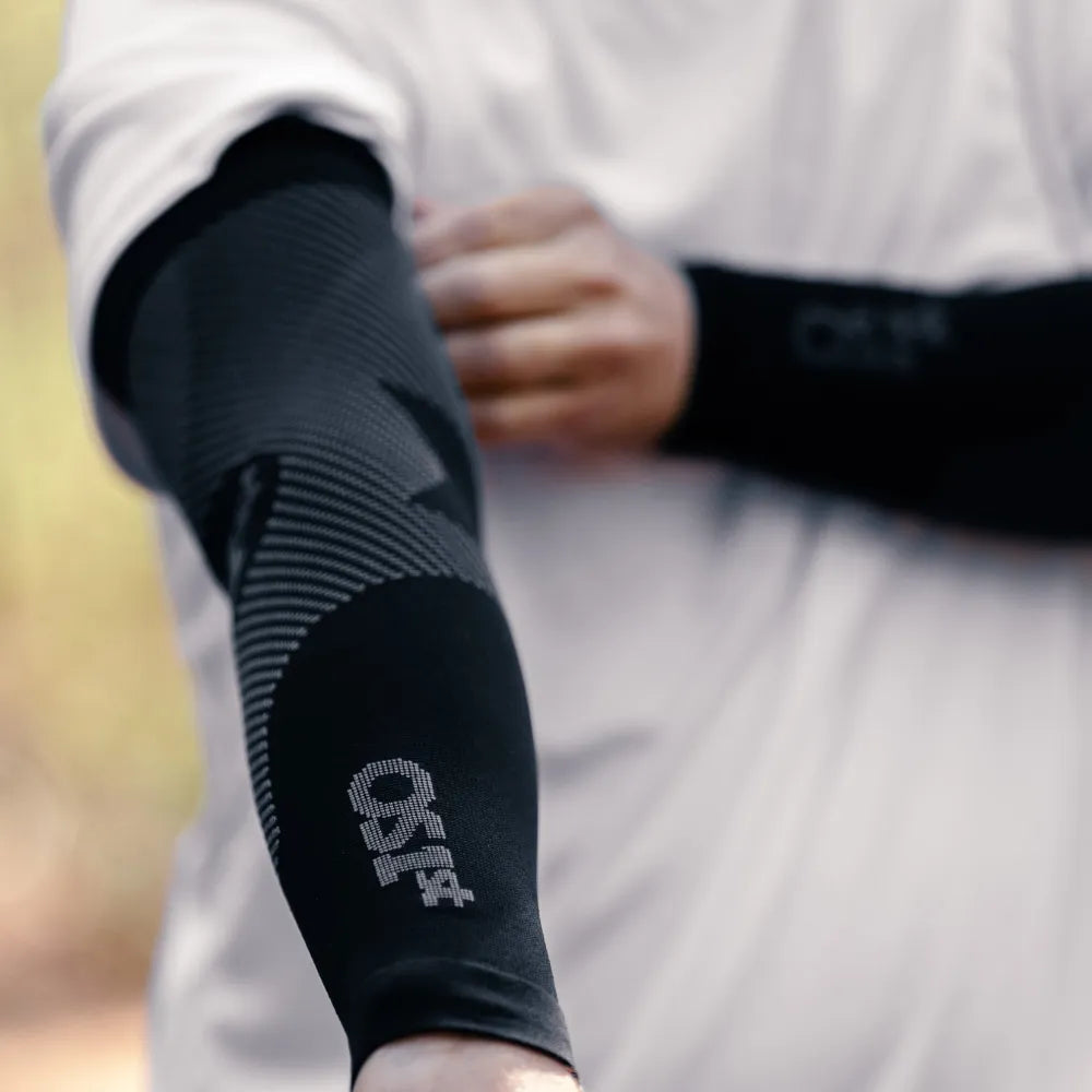 Black OS1st performance arm sleeve with compression zones on person's arm