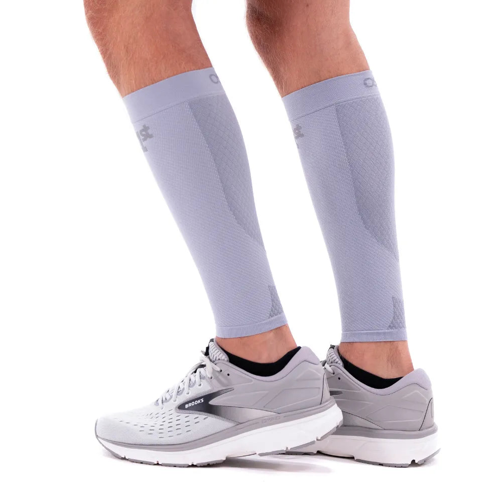 OS1st CS6 Performance Calf Sleeves in grey worn on legs with athletic shoes