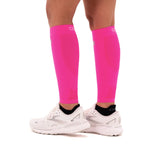 OS1st CS6 Performance Calf Sleeves in fluorescent pink worn on legs with running shoes