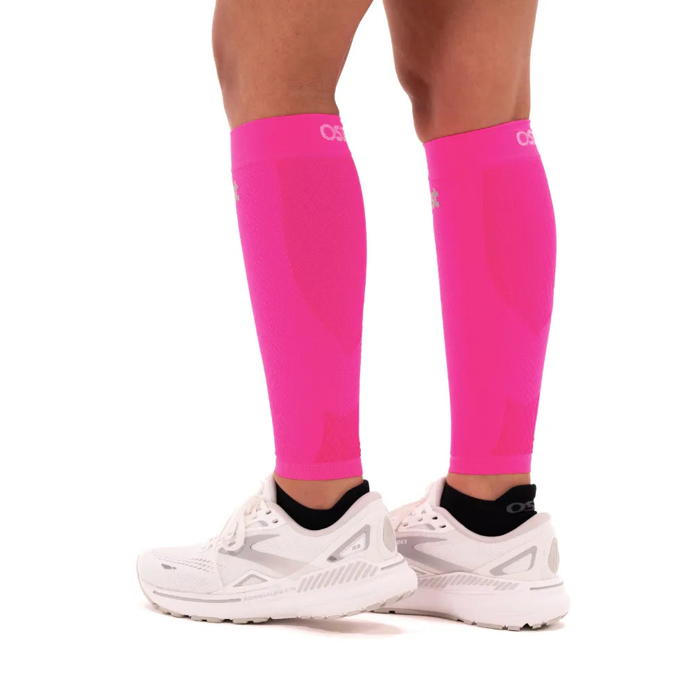 OS1st CS6 Performance Calf Sleeves in fluorescent pink worn on legs with running shoes