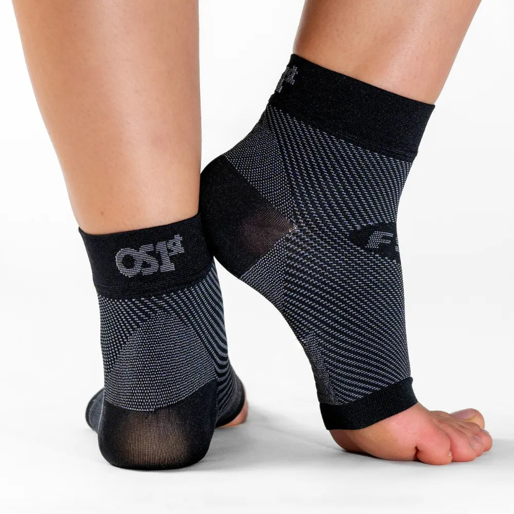 OS1ST FS6 Performance Foot Sleeves in black being worn on both feet