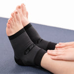 OS1ST FS6 Performance Foot Sleeves in black worn on feet during exercise