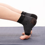 OS1ST FS6 Performance Foot Sleeves in black worn on feet during exercise
