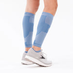 OS1ST TA6 Performance Calf Sleeves in steel blue worn on legs with athletic shoes