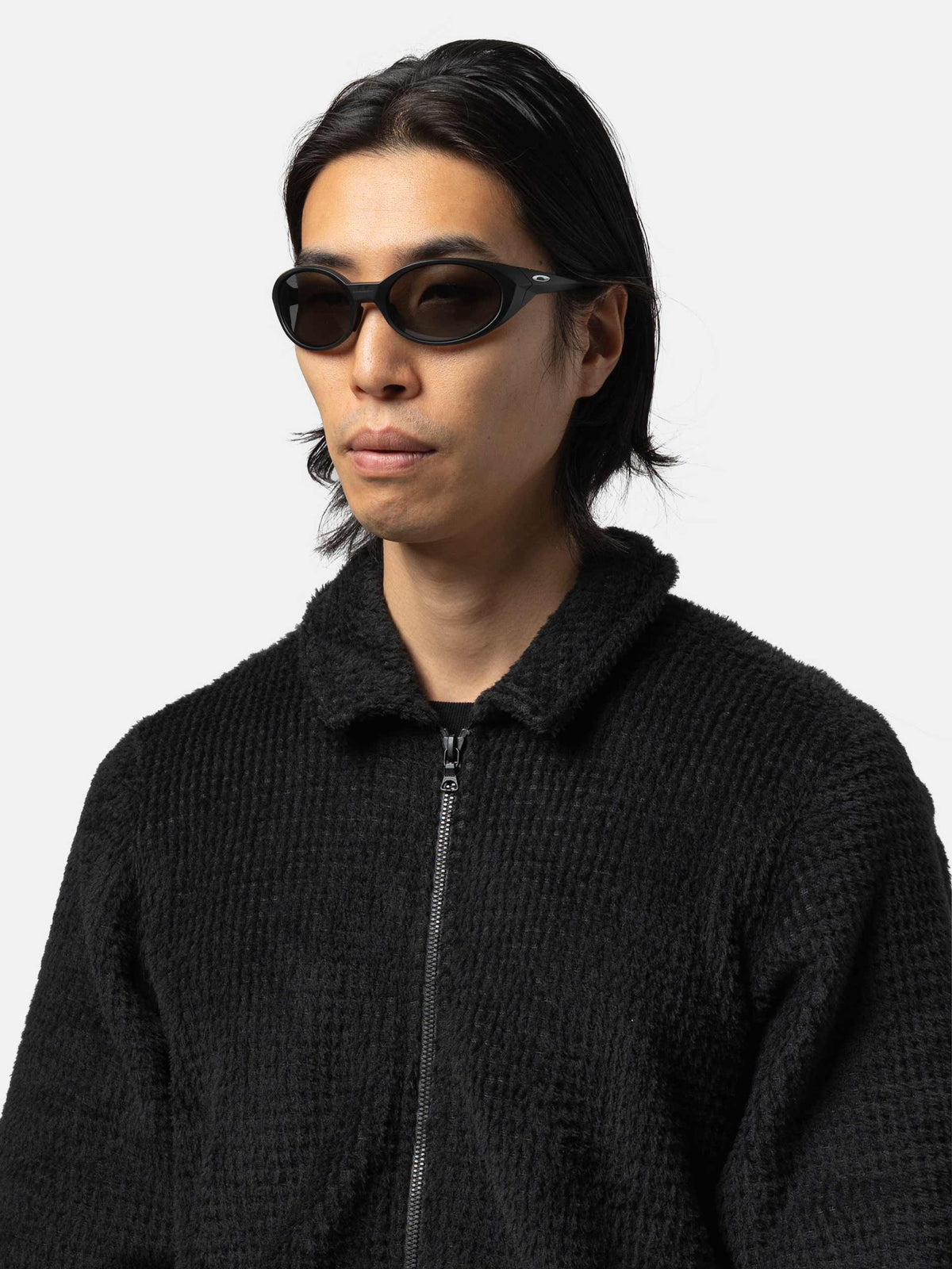 Male model wearing Oakley Eyejacket Redux sunglasses in matte black with PRIZM grey lenses