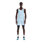 Man wearing light blue On Performance 2-in-1 running shorts with black compression layer