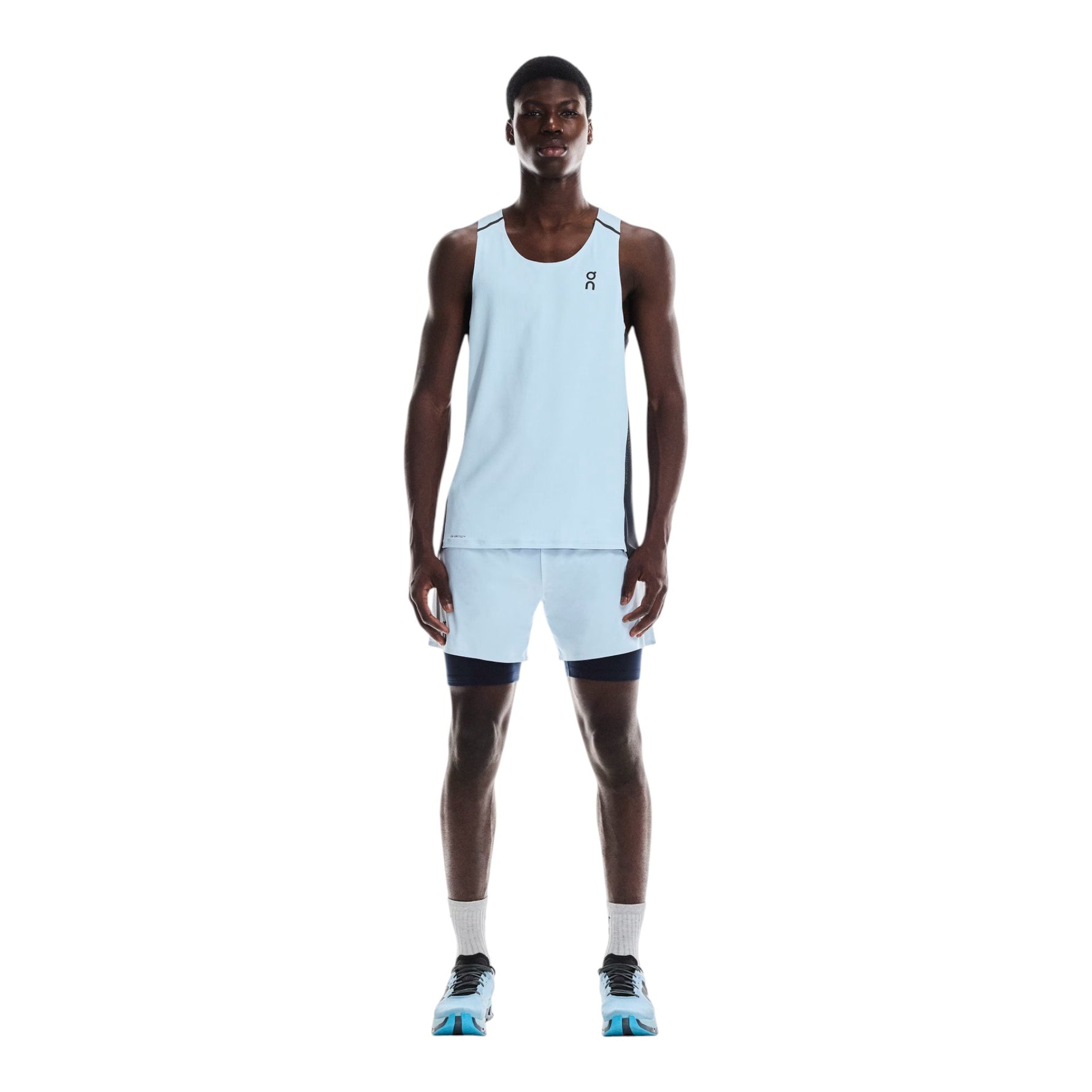 Man wearing light blue On Performance 2-in-1 running shorts with black compression layer