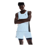 Man wearing On light blue tank top and matching shorts with navy accents