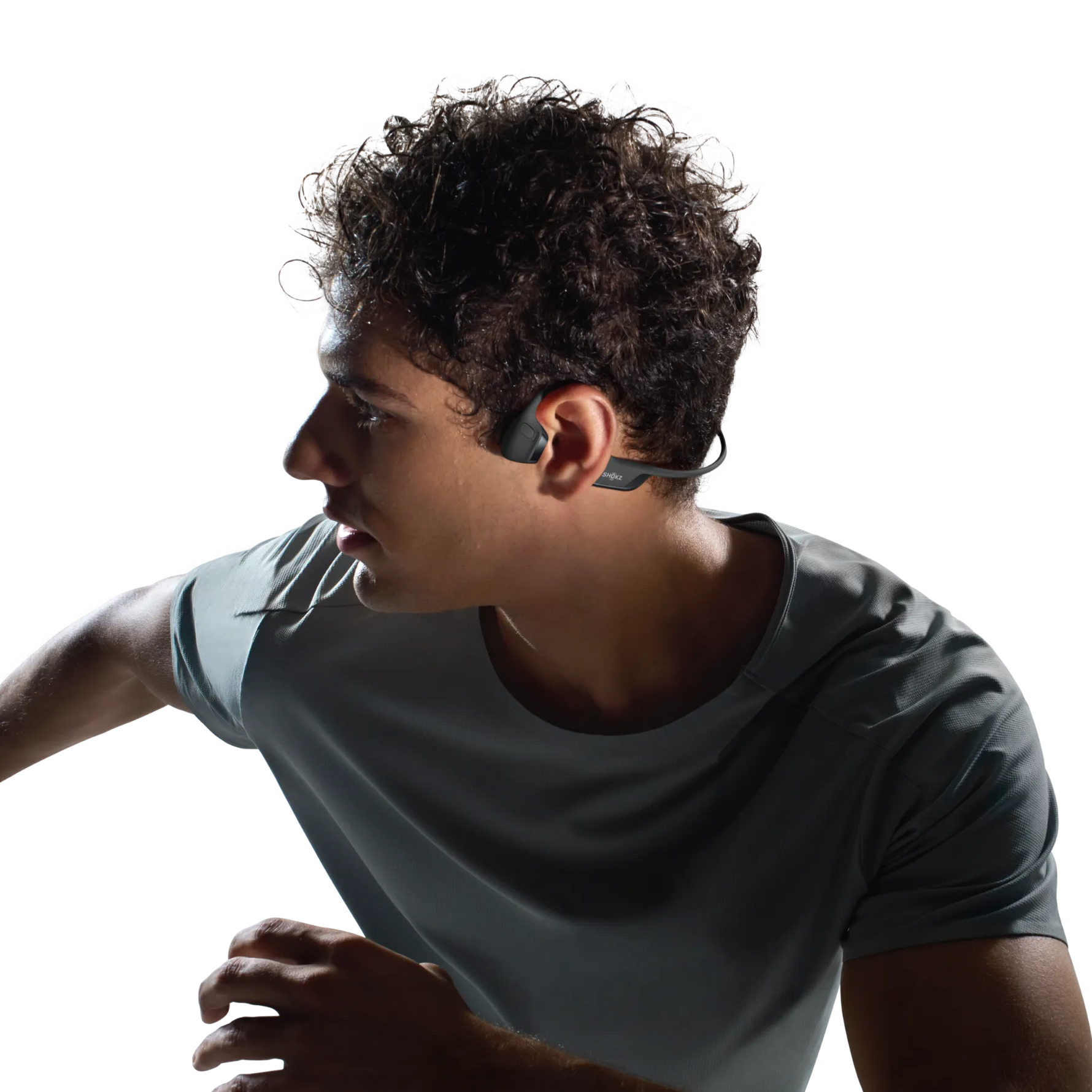 Person wearing Shokz bone conduction headphones while exercising in athletic wear