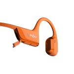Orange Shokz bone conduction headphones with open-ear design and charging cable