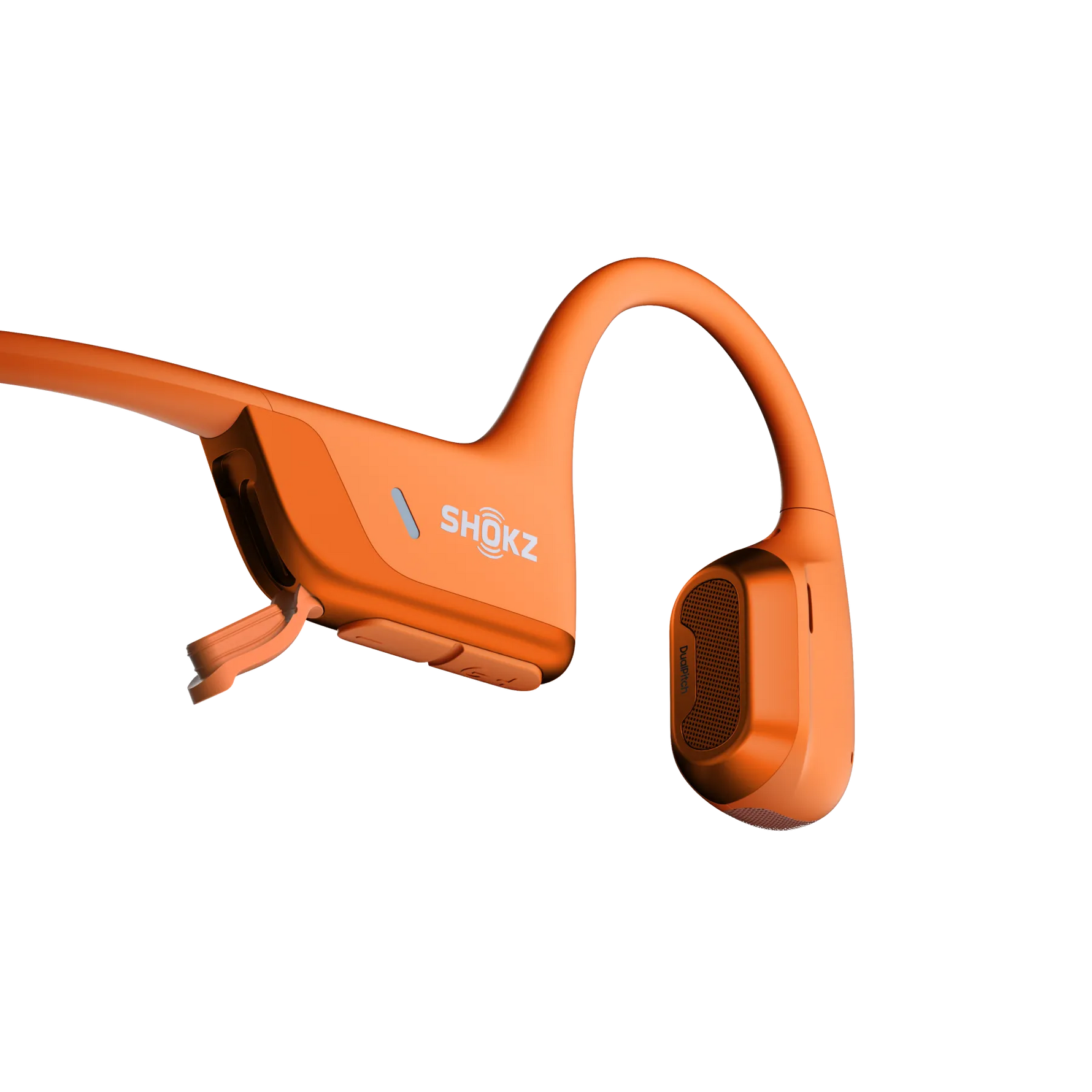 Orange Shokz bone conduction headphones with open-ear design and charging cable