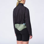 Woman wearing Salomon Active Belt 3D hydration waist pack in sage green while running