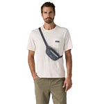 Man wearing dark blue Patagonia Terravia Mini Hip Pack crossbody style