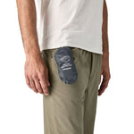 Patagonia Terravia Mini Hip Pack in navy blue attached to model's khaki pants