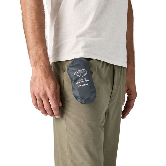 Patagonia Terravia Mini Hip Pack in navy blue attached to model's khaki pants