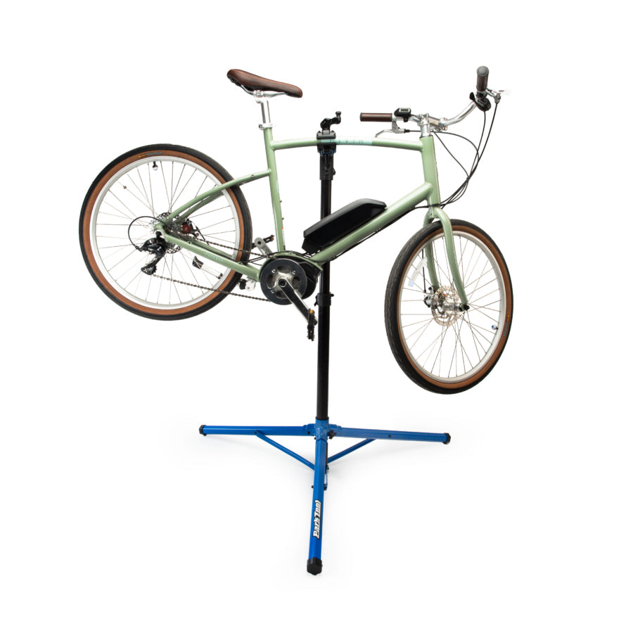 Park Tool PRS-26 Team Issue blue repair stand holding green bicycle
