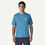 Man wearing light blue Patagonia t-shirt with small logo on chest