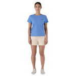 Woman wearing blue Patagonia P-6 Logo Responsibili-Tee with beige shorts