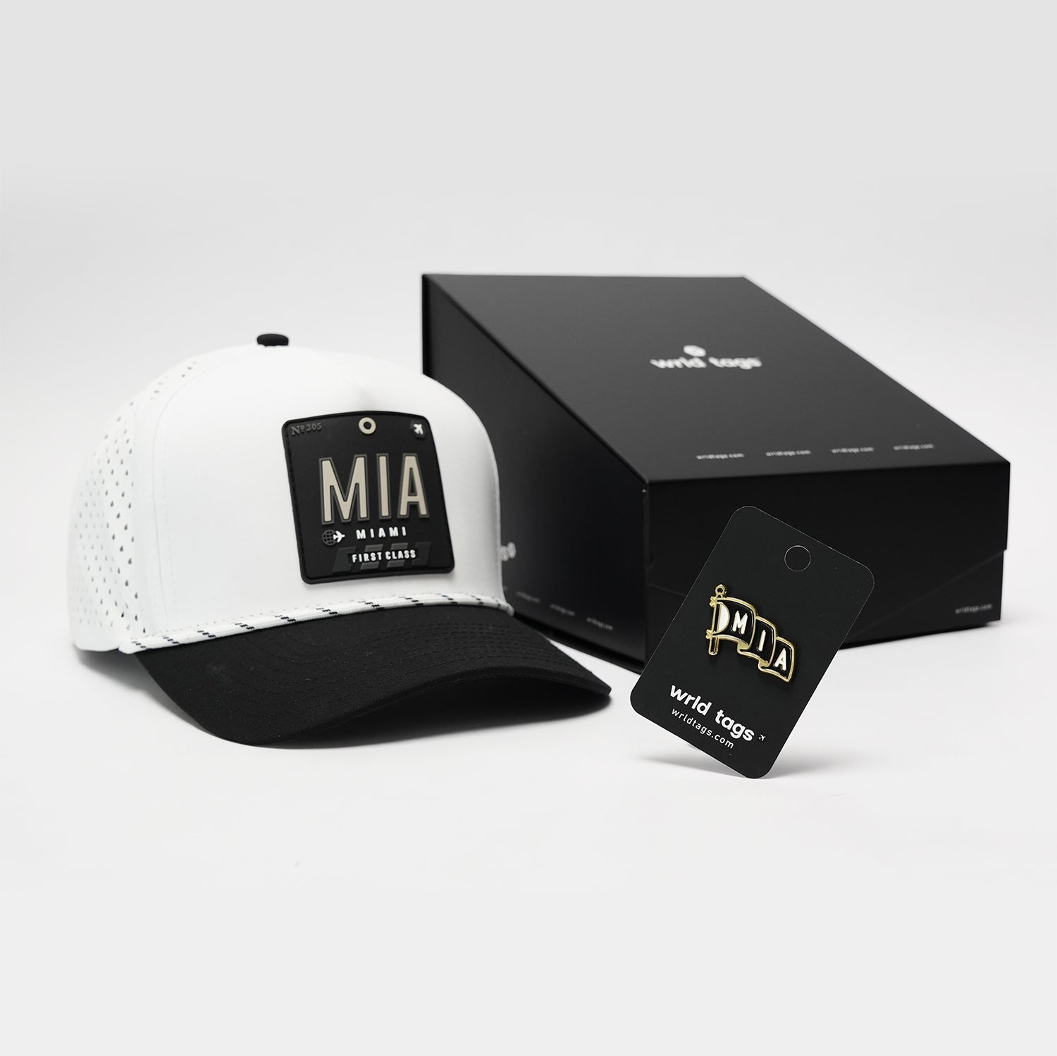 White Miami trucker hat with black visor by Wrld Tags, professional product shot