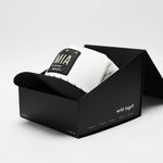 White and black Miami trucker hat by Wrld Tags in black packaging box