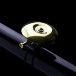 Lezyne Classic Shallow Brass Bell mounted on bicycle handlebar with gold finish