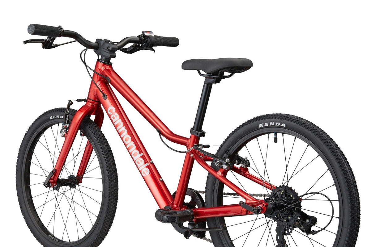 Close-up of Cannondale Kids Quick C2 metallic red frame with handlebars and saddle detail