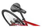 Cannondale Quick 3 bicycle rear section showing metallic red frame and black saddle