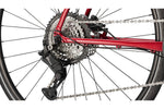 Close-up of Cannondale Quick 3 bicycle rear wheel showing metallic red frame and drivetrain components