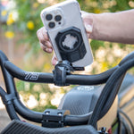 Rokform Universal Adapter mounted on bicycle handlebars with iPhone attached