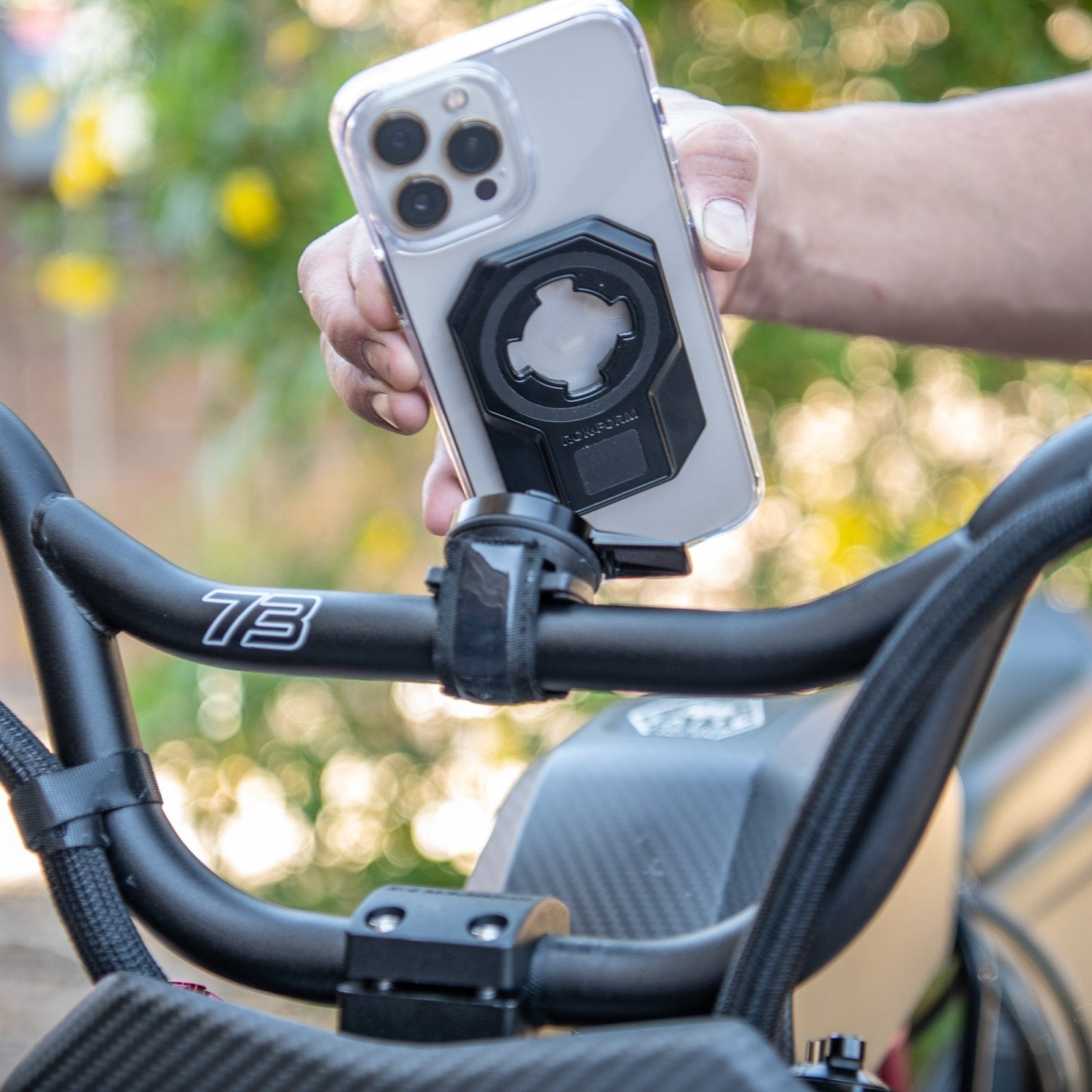 Rokform Universal Adapter mounted on bicycle handlebars with iPhone attached