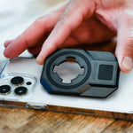 Rokform Universal Adapter with circular mount attachment being held over smartphone