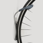 Delta grey wall-mounted bike rack holding bicycle wheel against white background