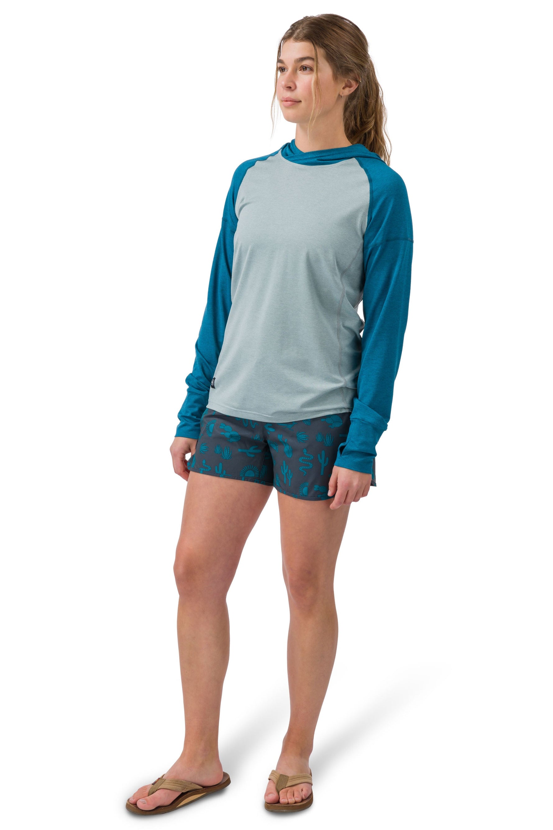 Woman wearing Flylow Moonlight hoodie in cloud colorway with blue sleeves
