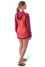 Woman wearing coral and purple hooded long-sleeve shirt viewed from behind