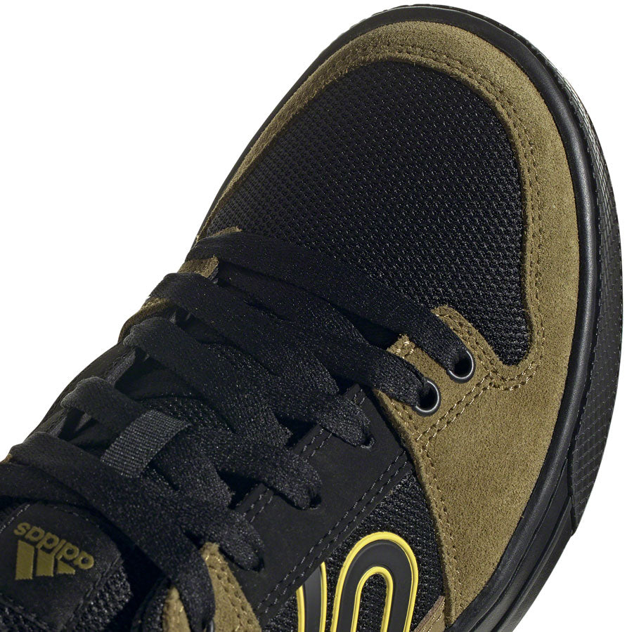 Five Ten Freerider MTB shoe in black with olive green trim and yellow accents