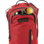 Dakine Shuttle 6L backpack in deep red with sunglasses and water bottle